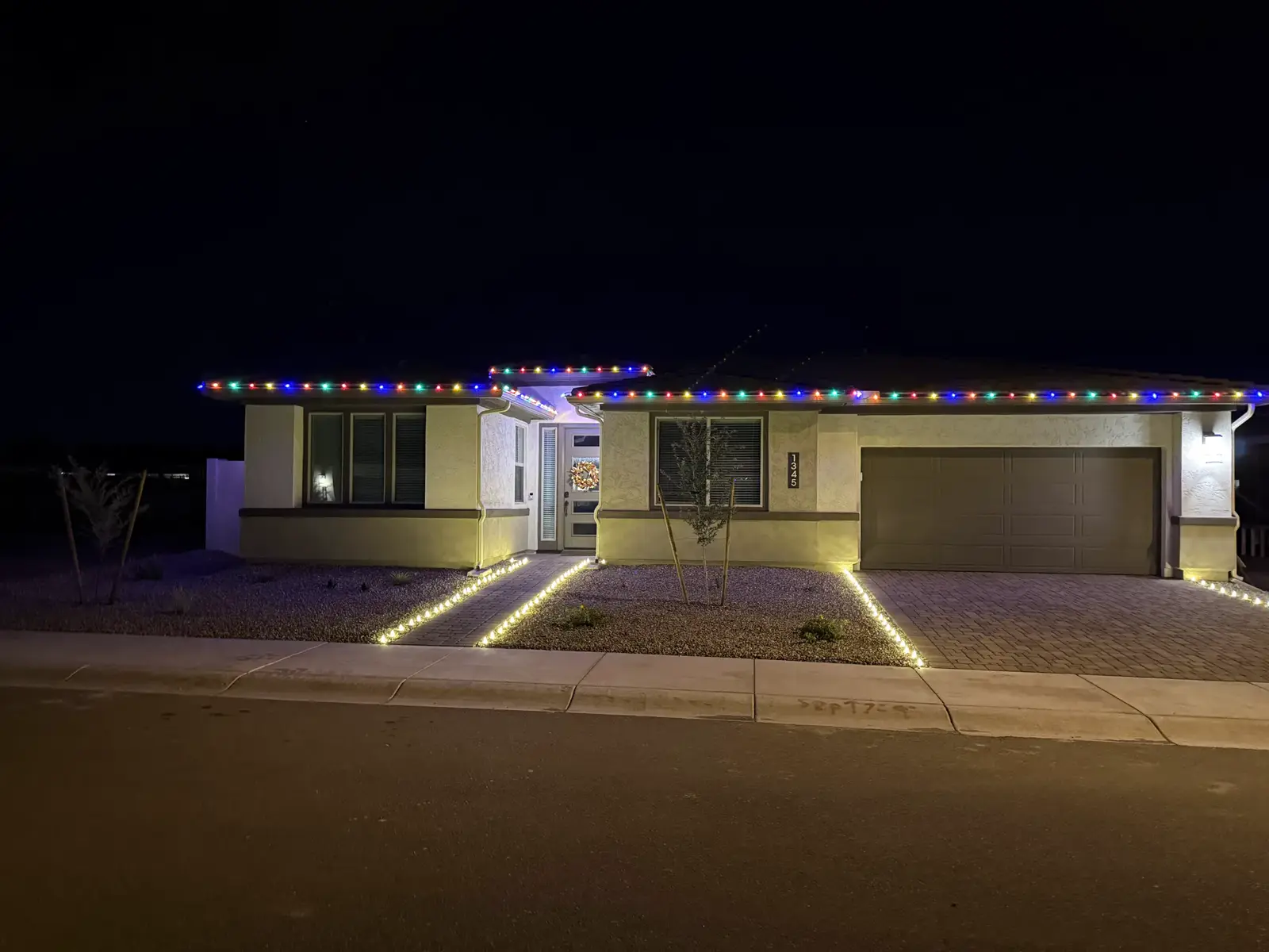 Home outlined in multicolor lights along the roofline and walkway